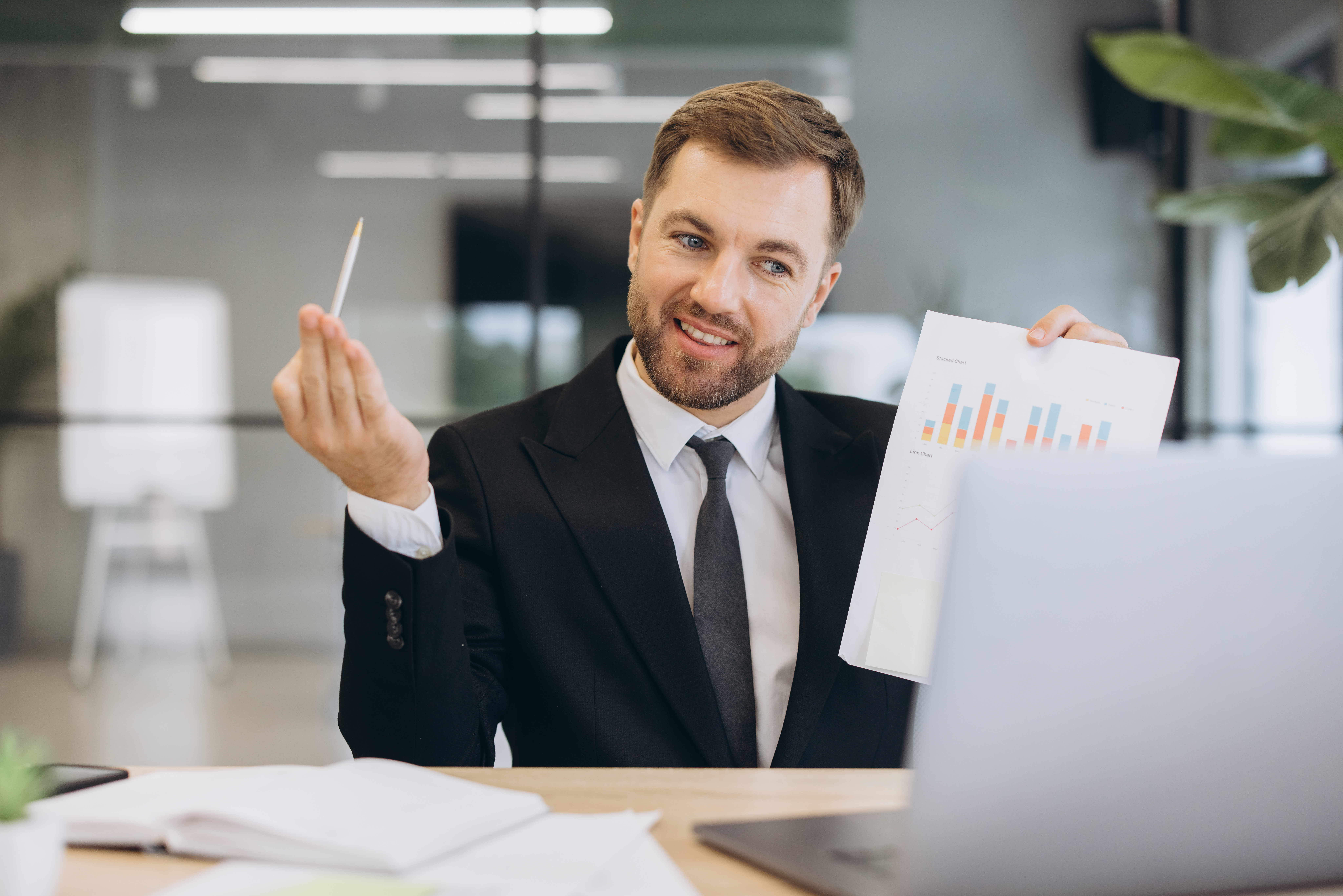 Businessman presenting financial data using a chart during a video call, discussing business strategy and analysis from his office